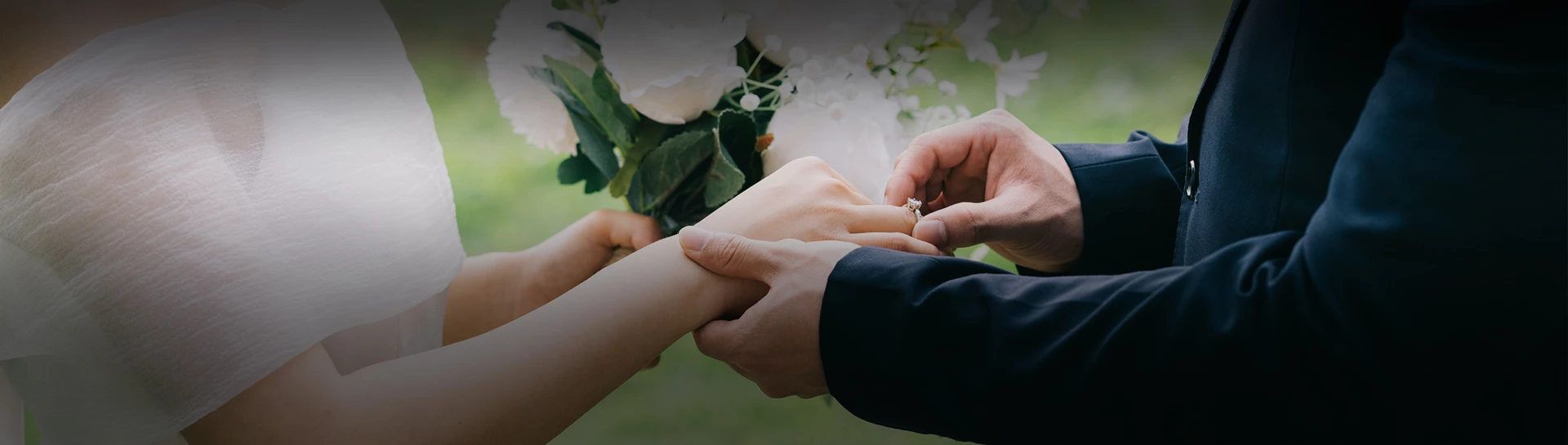 a man putting a ring on a woman's hand