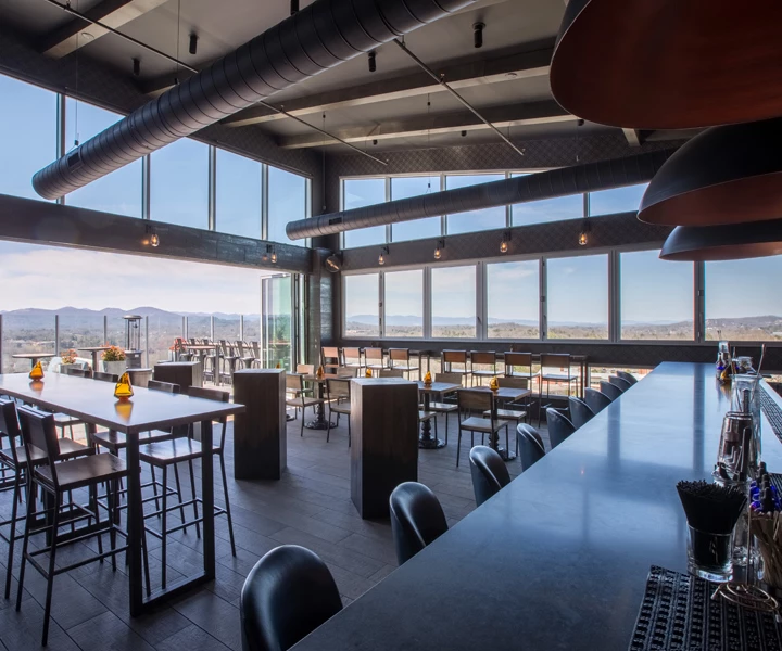 a rooftop bar with tables and chairs