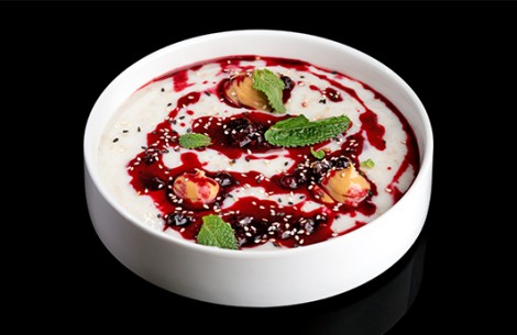a bowl of food with red sauce and mint leaves