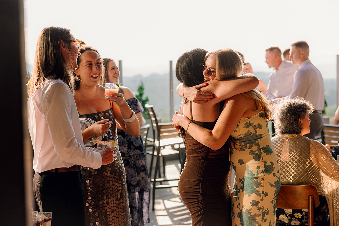 a group of women hugging and smiling