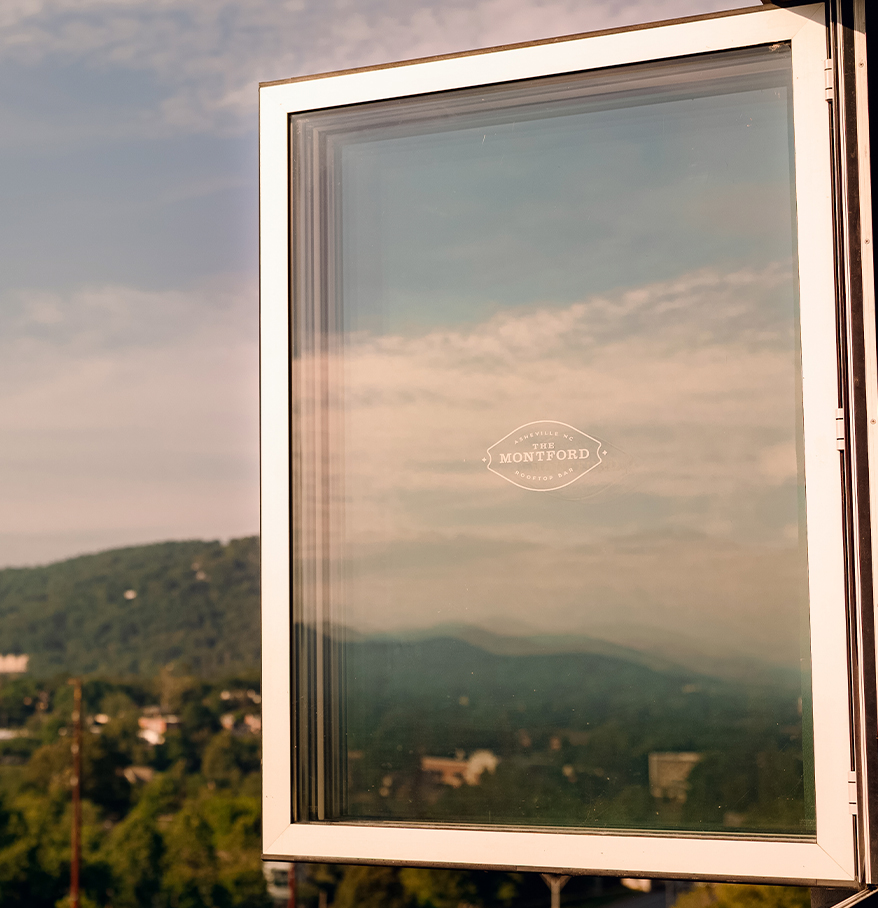 a window with a view of a mountain range
