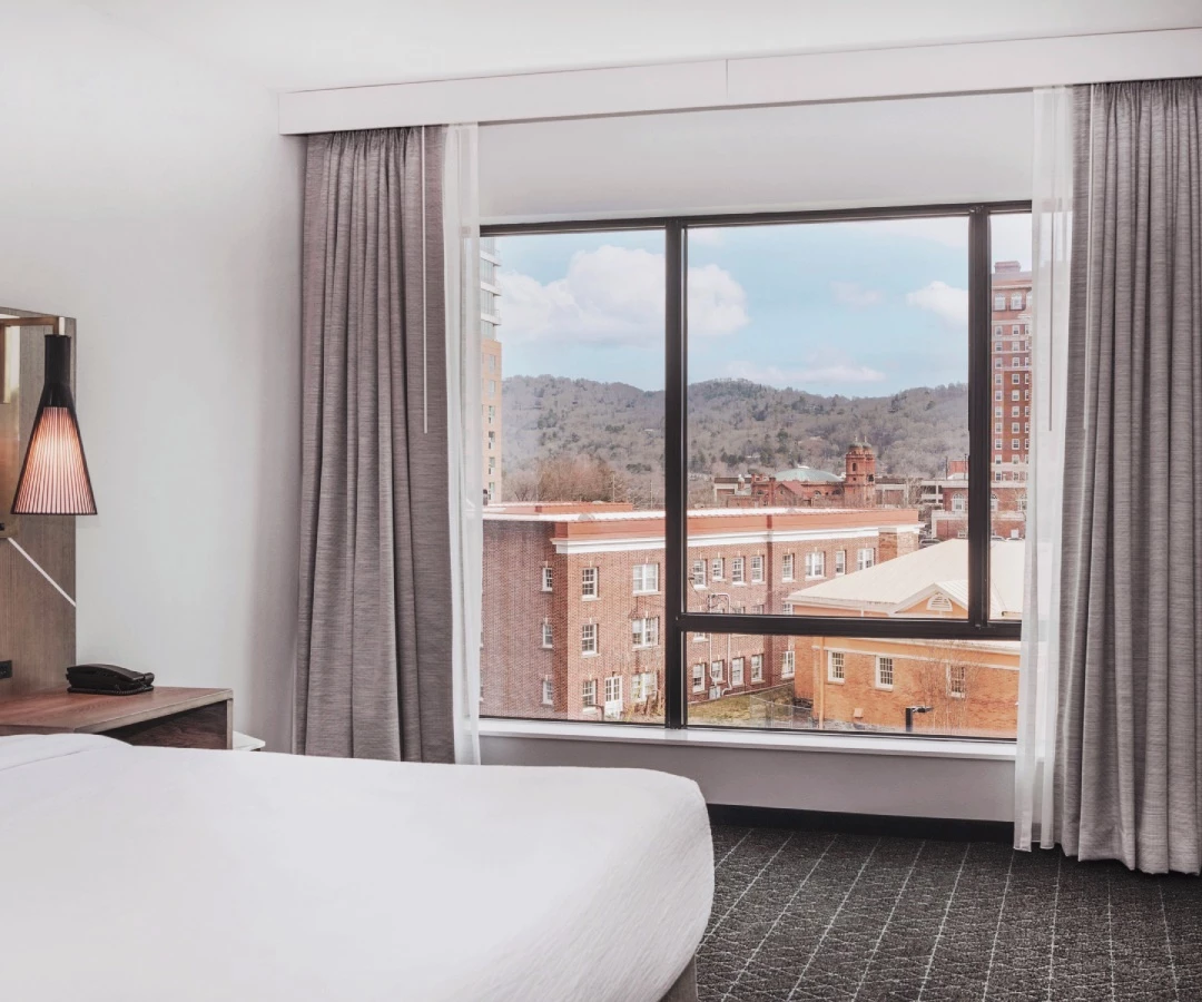 a bedroom with a large window