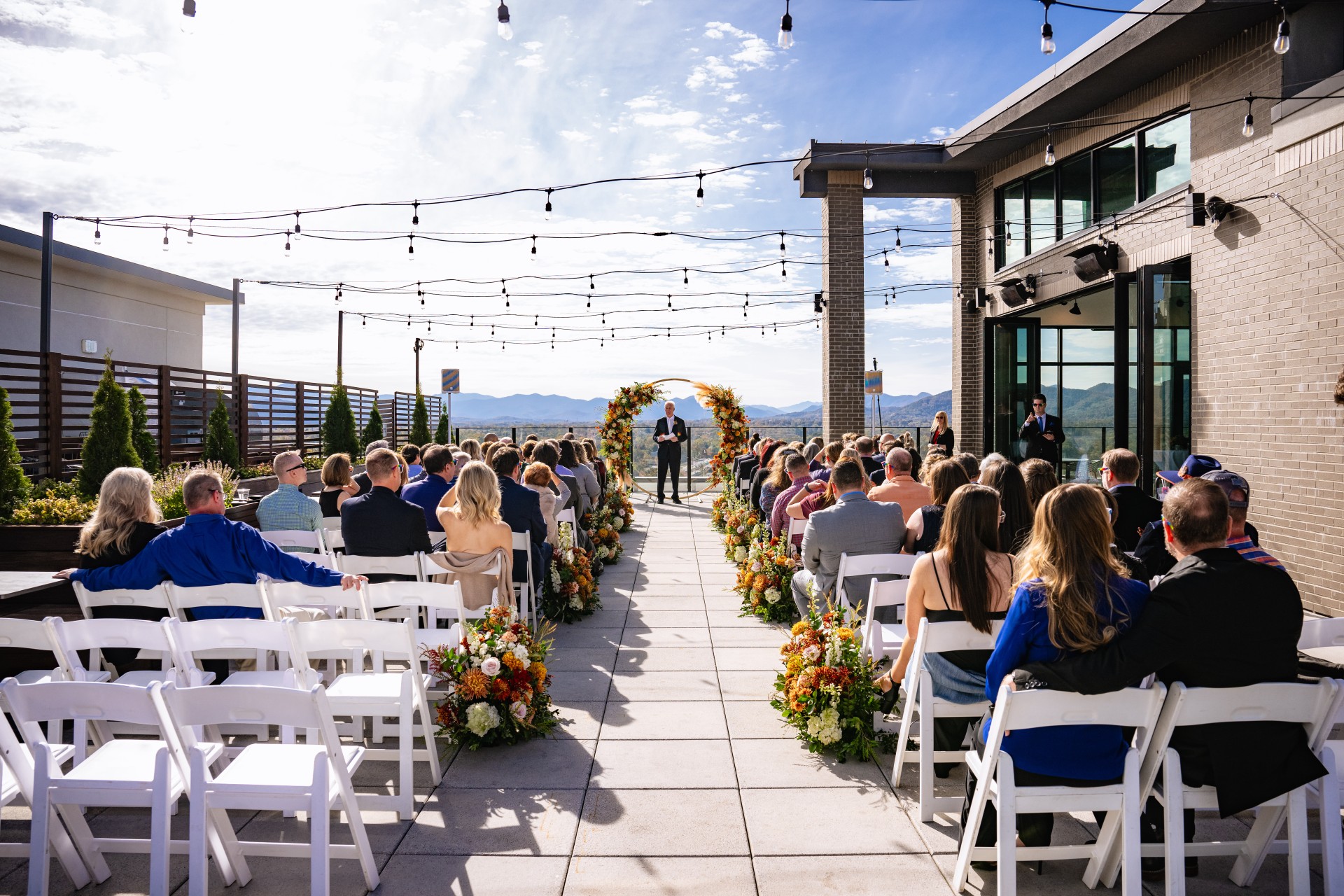 a man standing on a walkway with a crowd of people