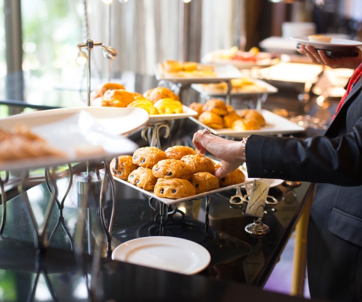 a person holding a plate of food