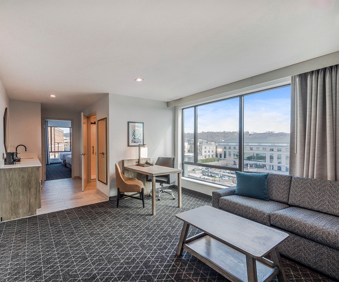 a room with a couch and table and chairs