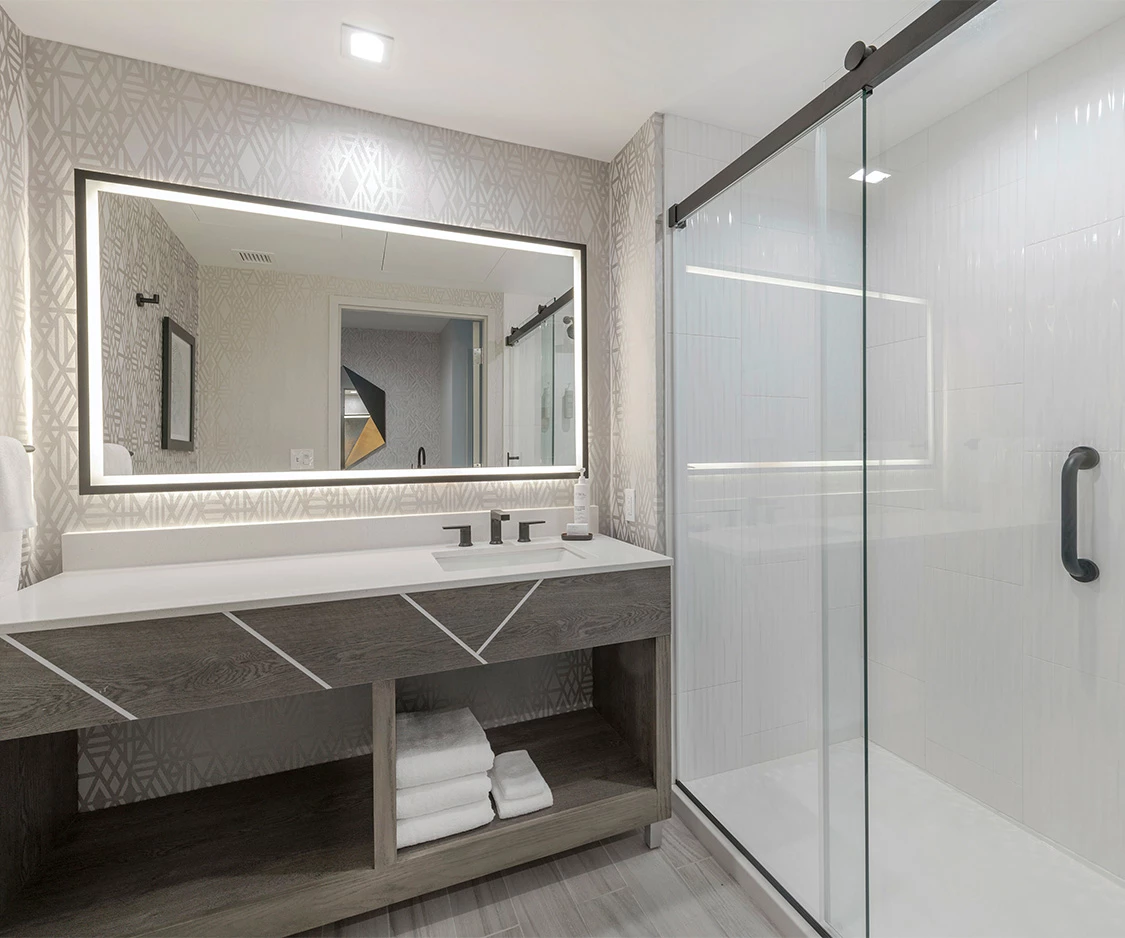 a bathroom with a glass shower and a sink