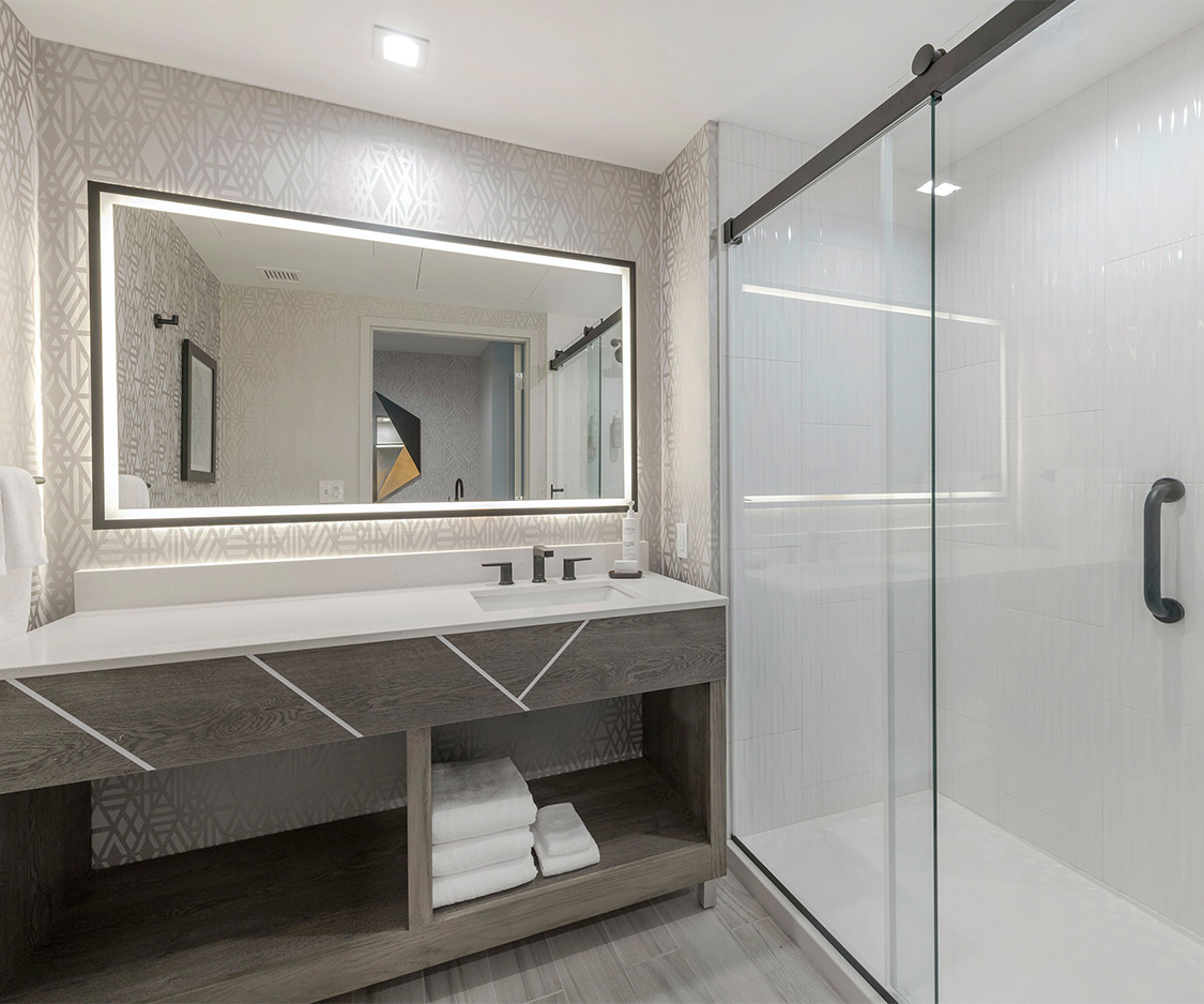 a bathroom with a mirror and a shower