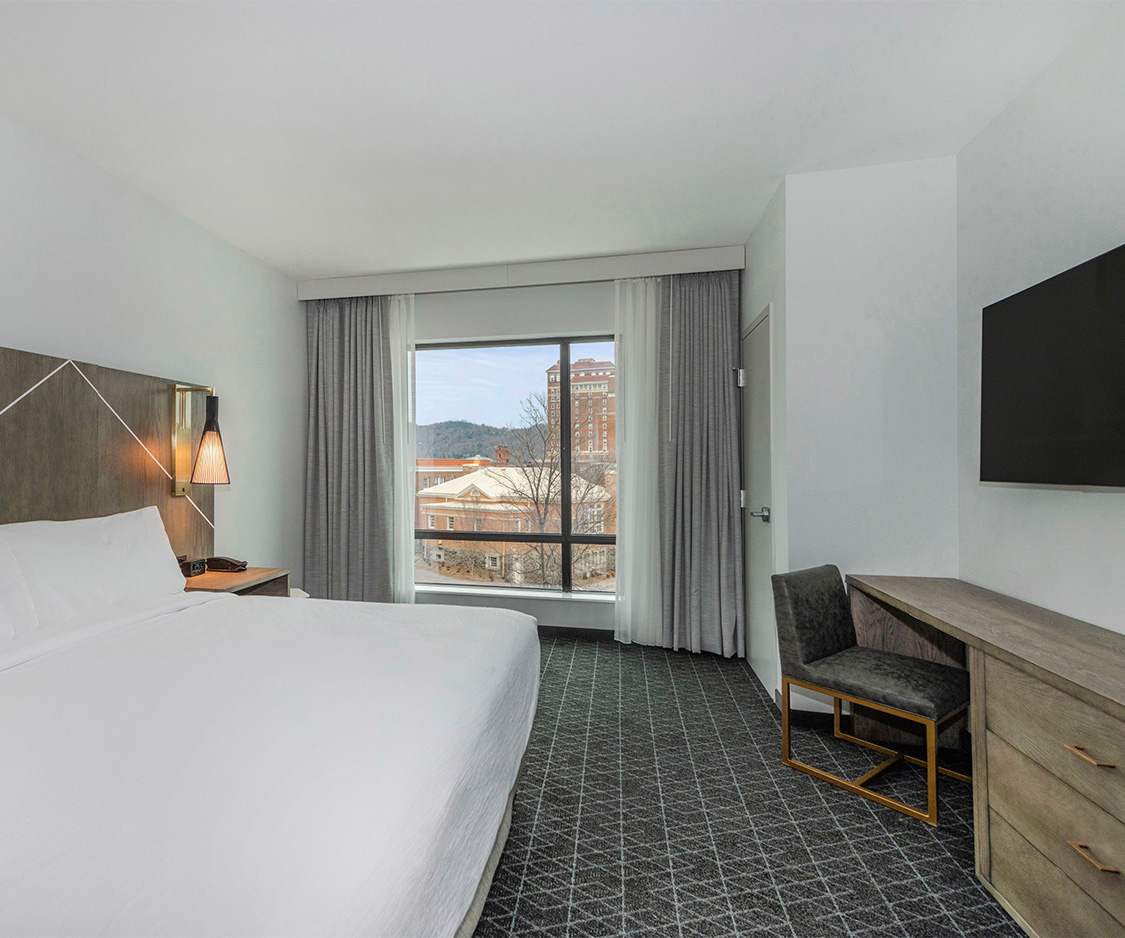 a bedroom with a bed and a television