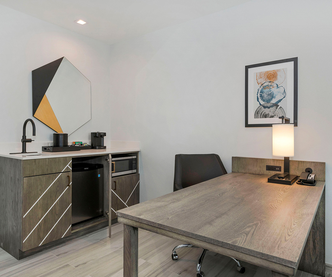 a room with a desk and a microwave