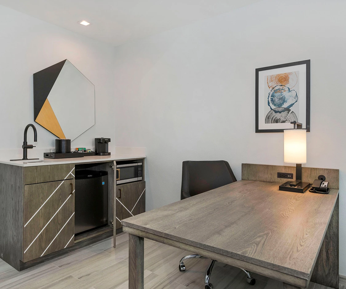 a room with a desk and a microwave