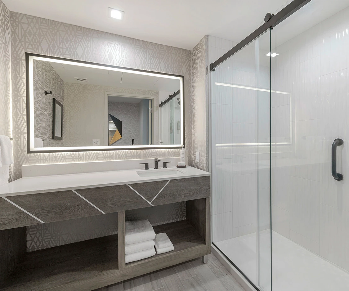 a bathroom with a mirror and a shower