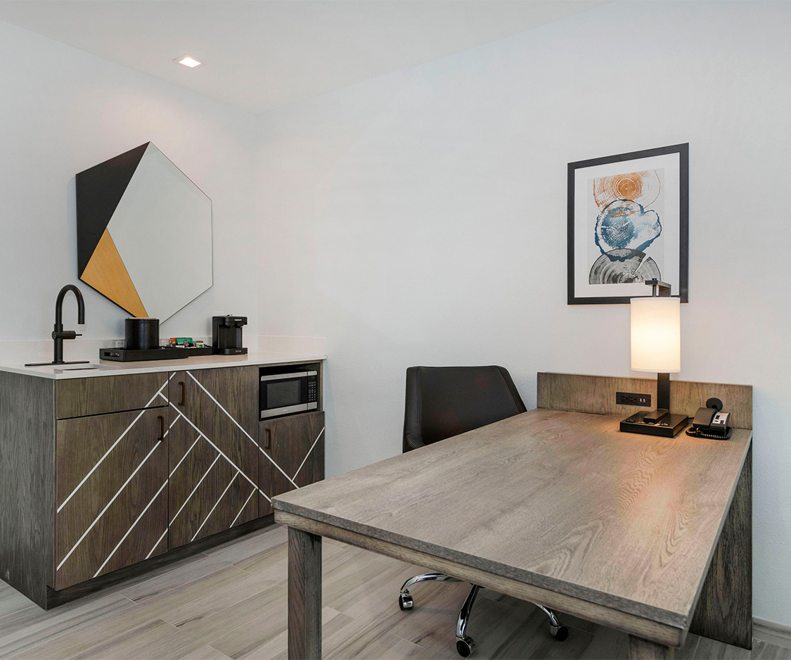 a room with a table and a microwave