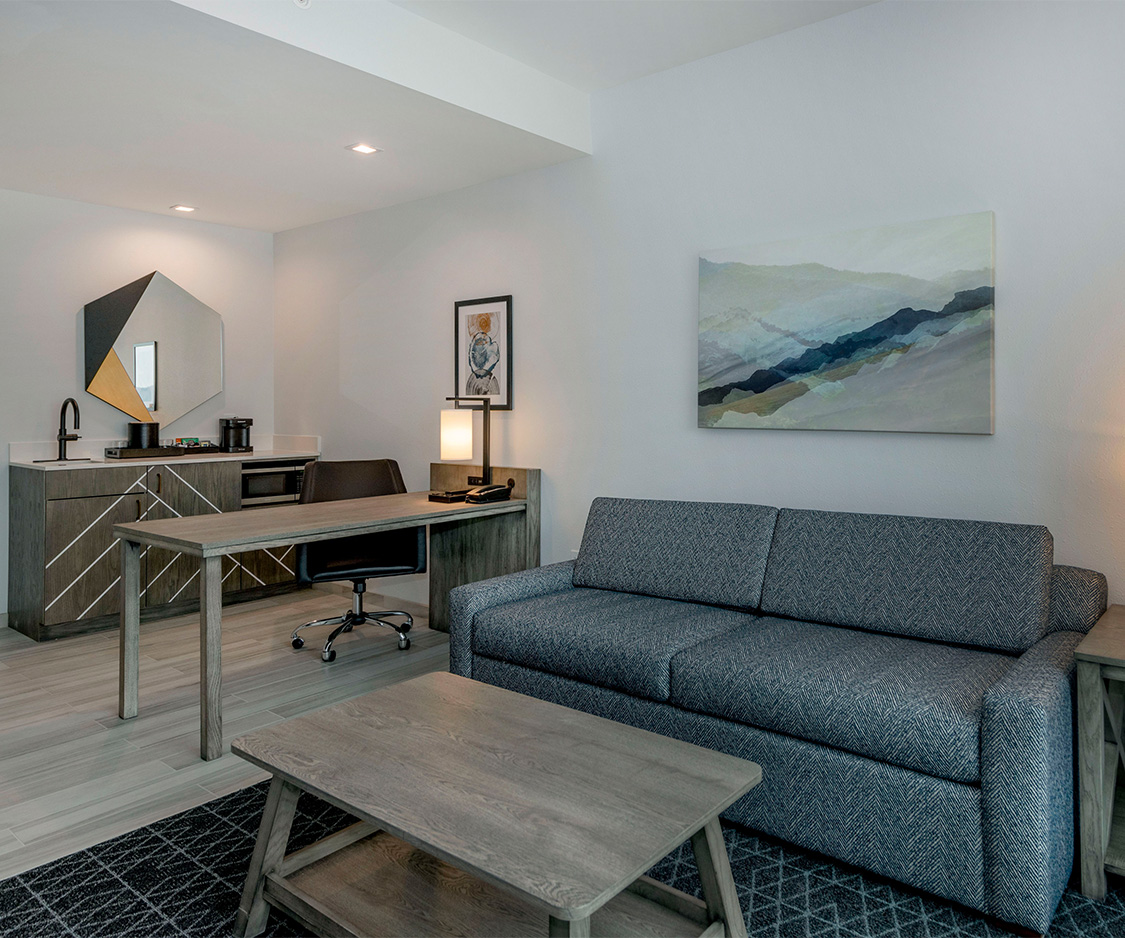 a room with a couch and a desk