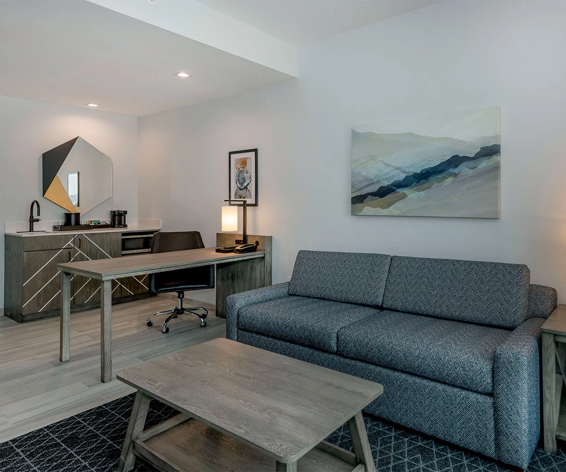 a room with a couch and a desk