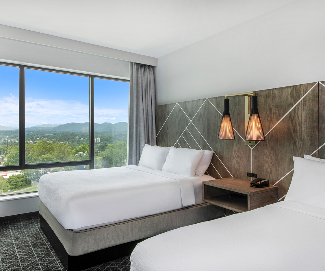 a room with two beds and a window