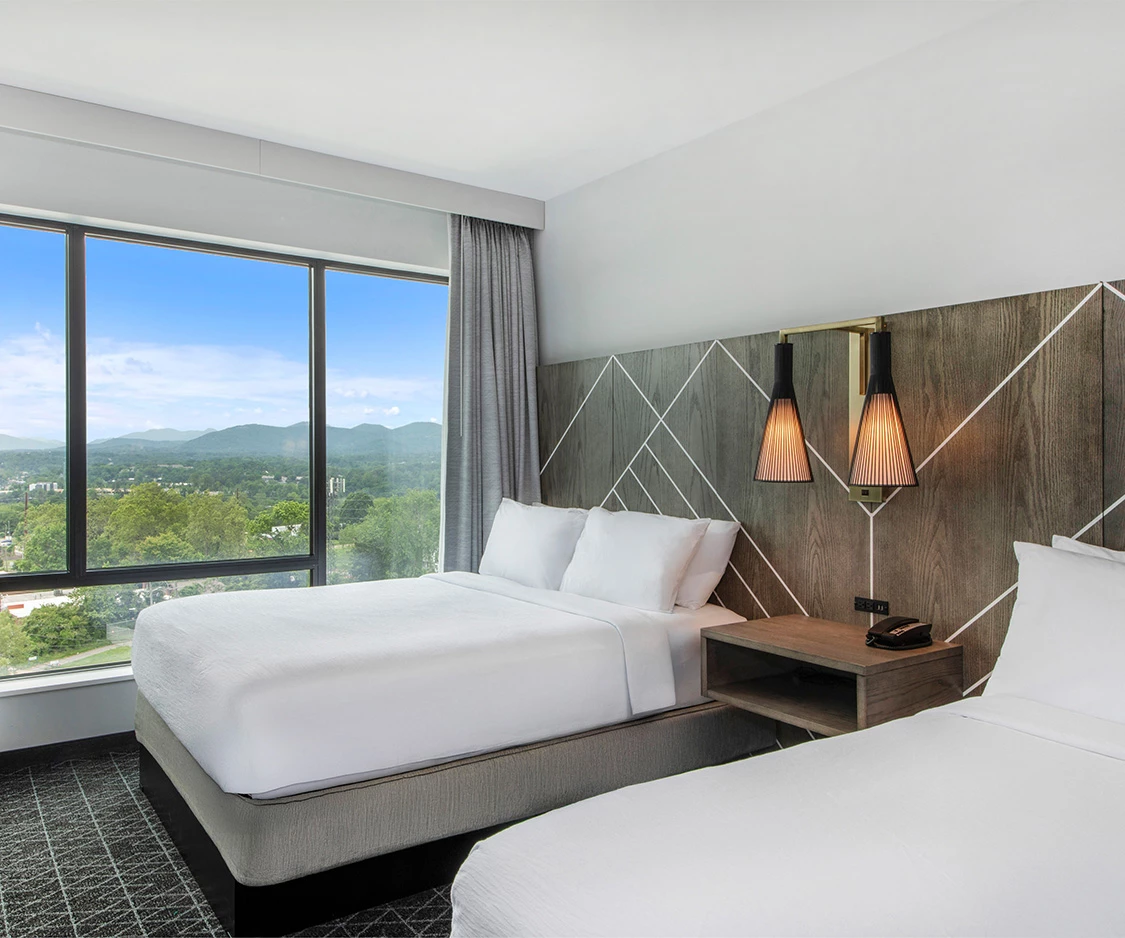 a room with two beds and a window