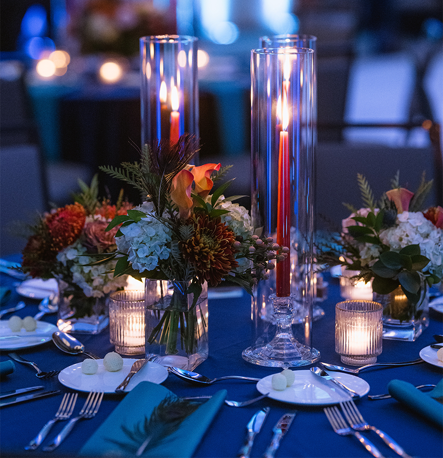 a table set with flowers and candles