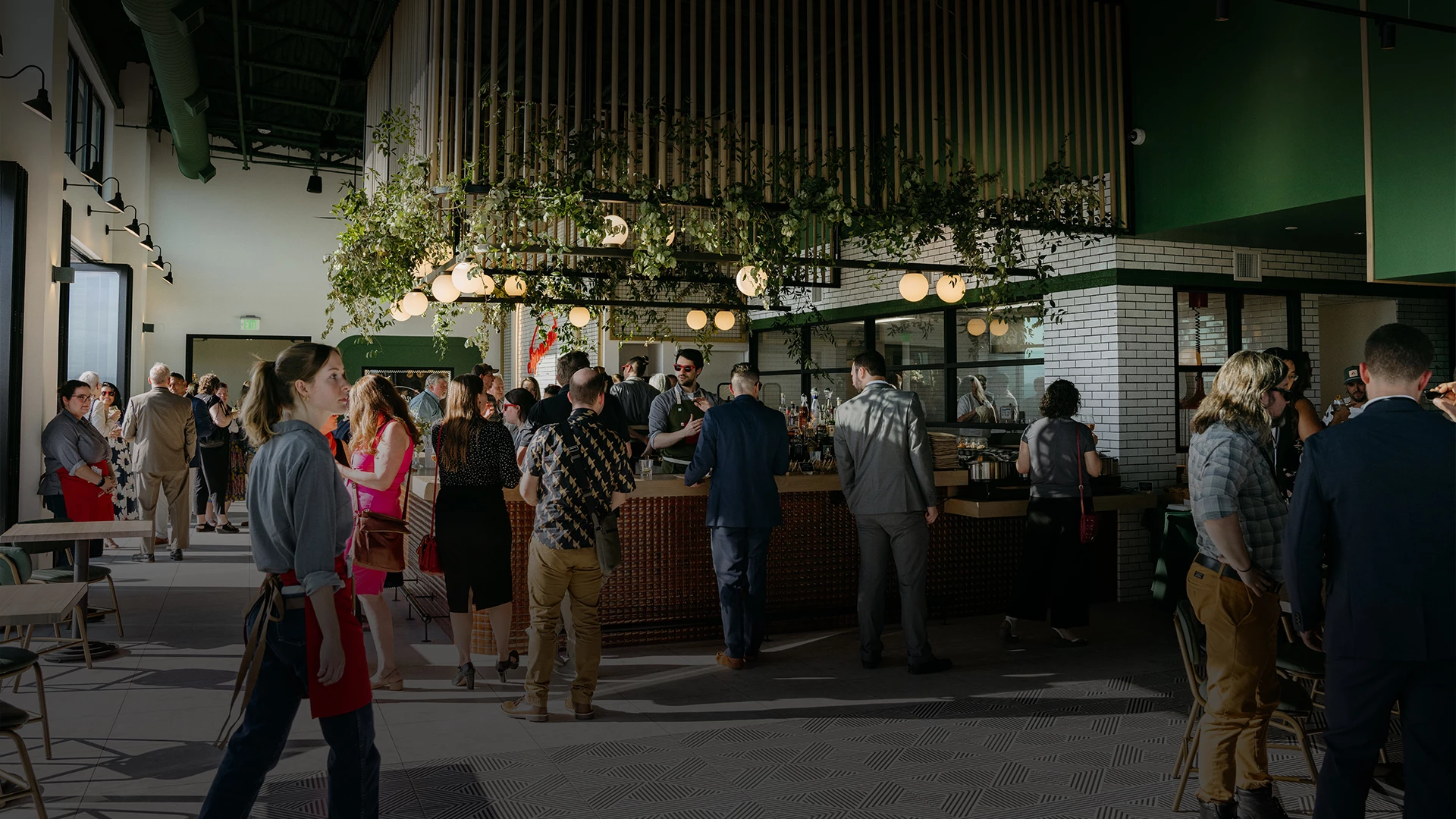 a group of people standing around a bar