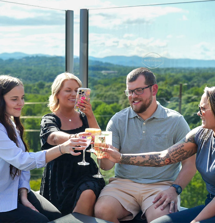 a group of people sitting on a balcony with drinks