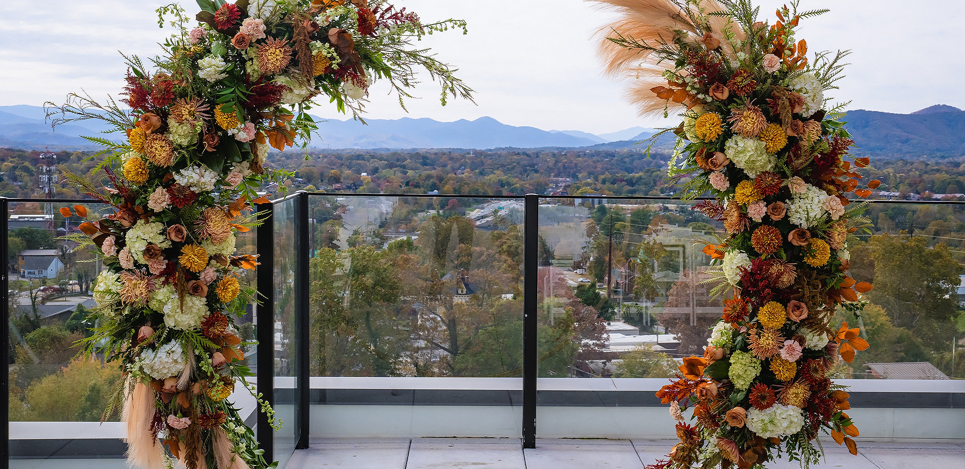 a balcony with a view of a city and mountains