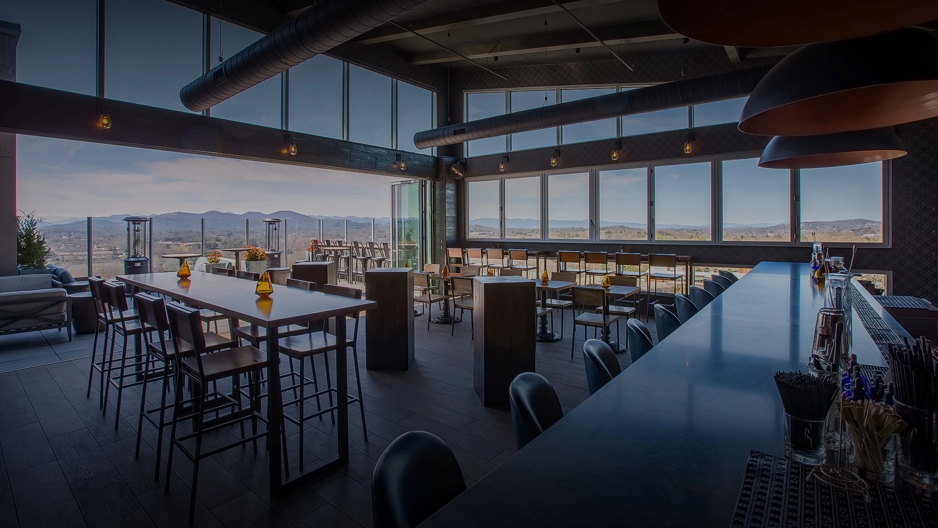 a rooftop restaurant with mountain views