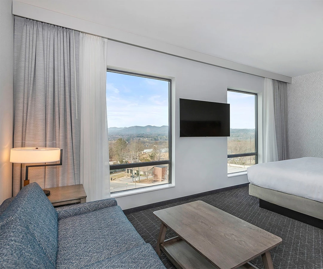 a bedroom with a large window