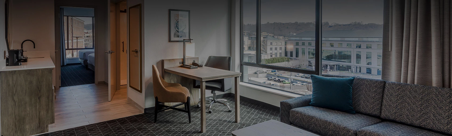 a room with a table and chairs and a window