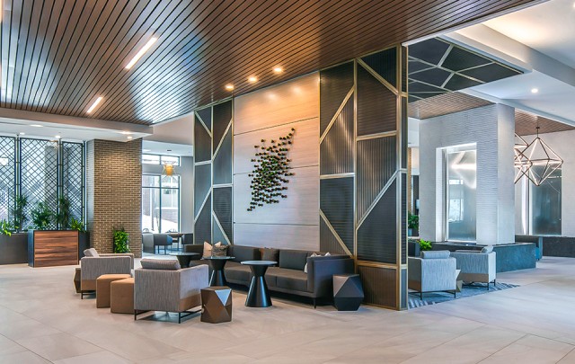 a lobby with a couch and chairs