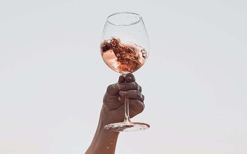 a hand holding a glass of wine