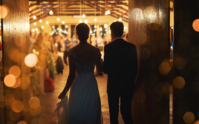 a man and woman walking down a hallway