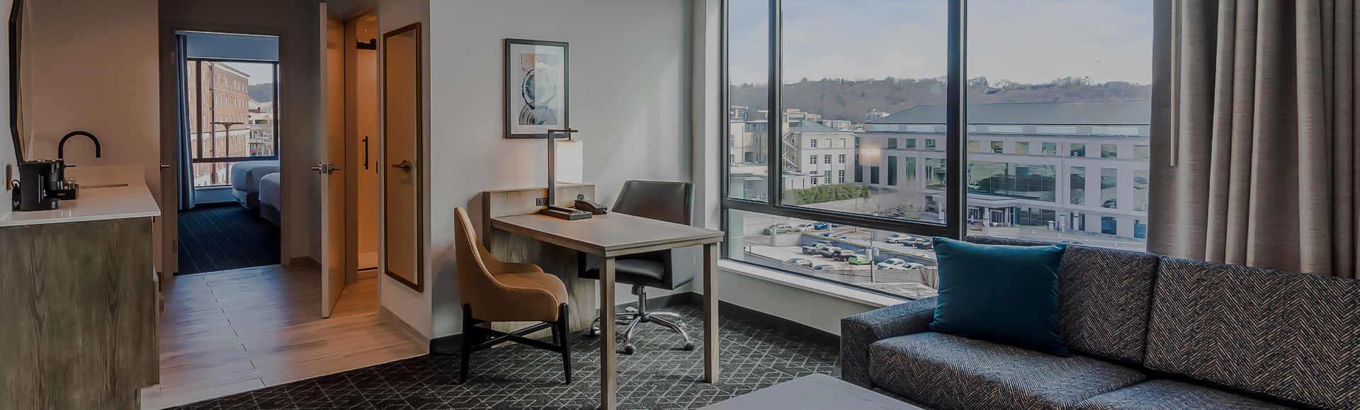 a room with a desk and chairs and a lamp