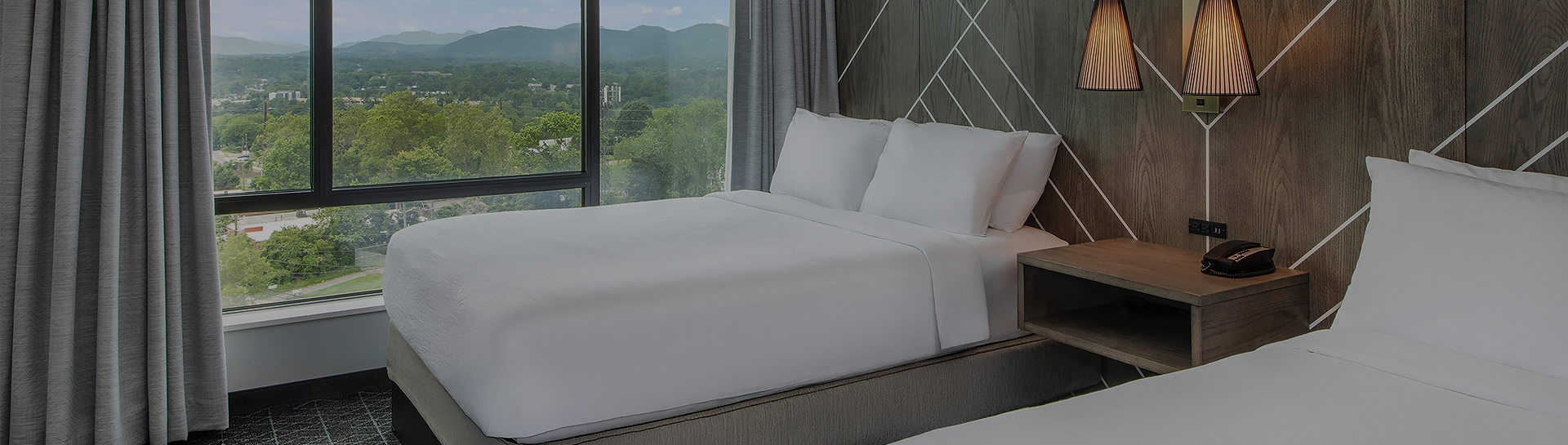 a bed with white sheets and pillows