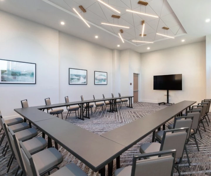 a room with a long table and chairs