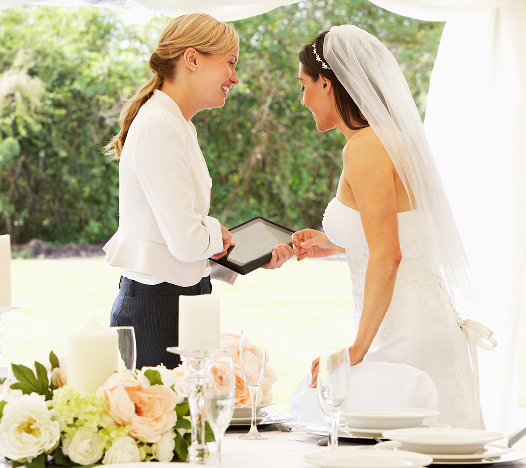 a bride and a groom holding a tablet