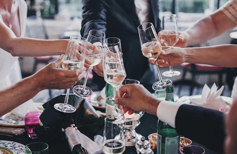 a group of people holding wine glasses