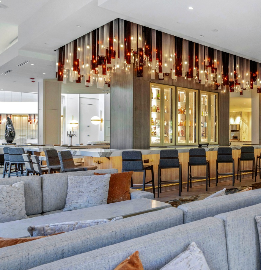 a room with a bar and chairs