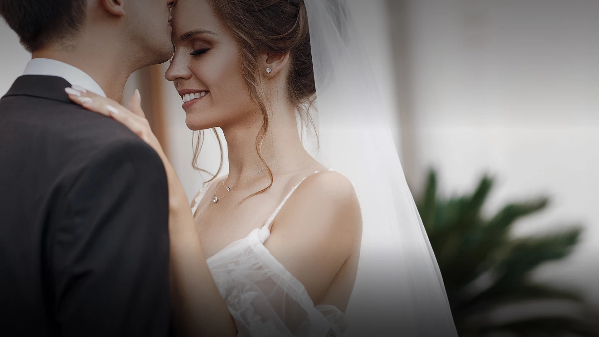 a man and woman kissing on their wedding day
