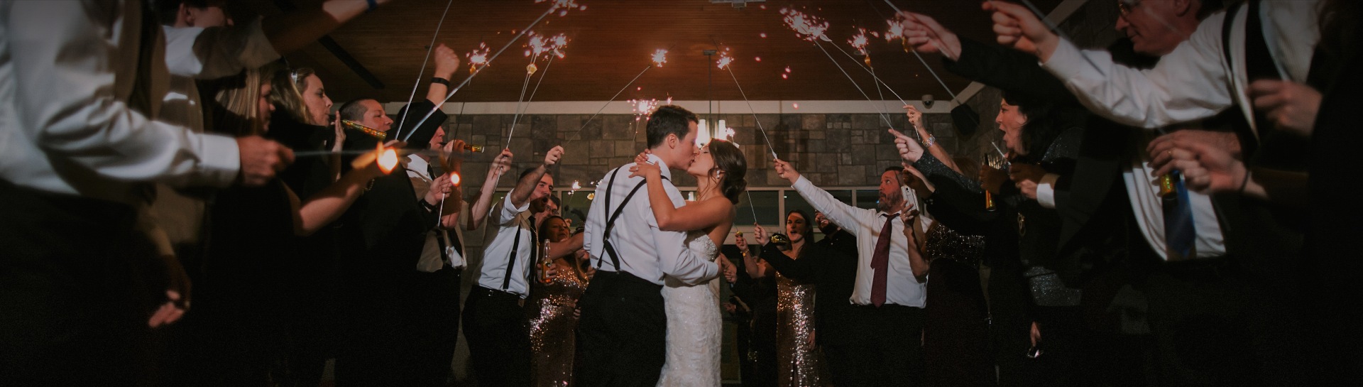 a man and woman kissing and holding sparklers on their wedding day
