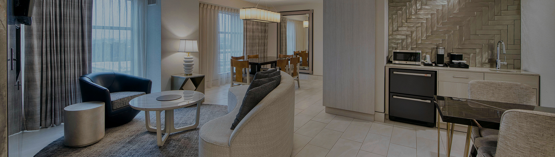 a hotel room with a couch and a table