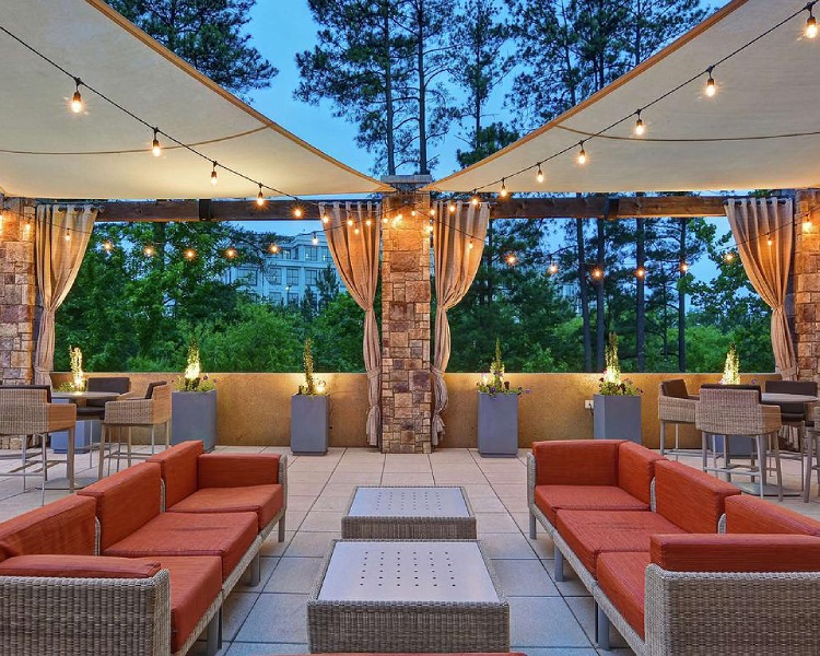 hotel patio with a covered patio with a table and chairs
