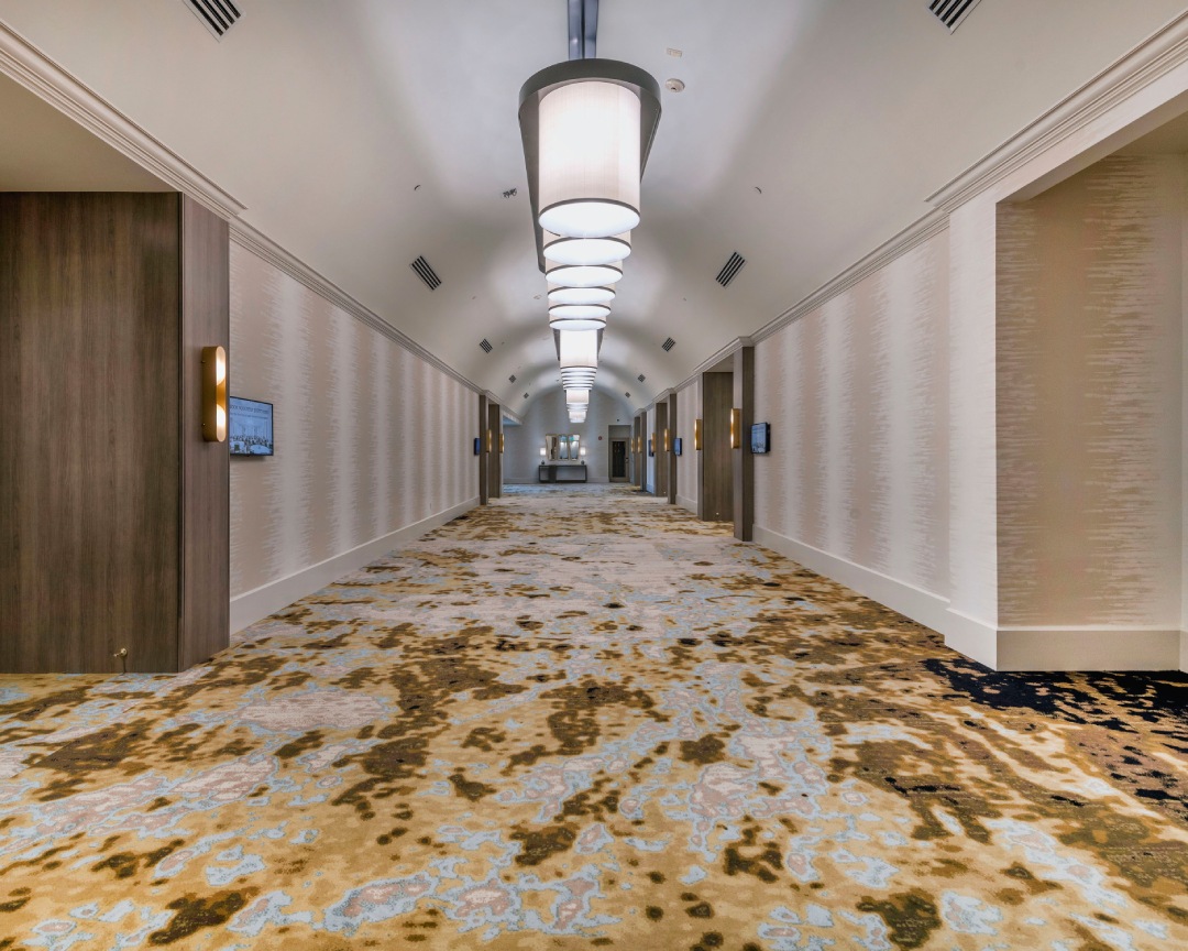 a hotel hallway with lights from the ceiling