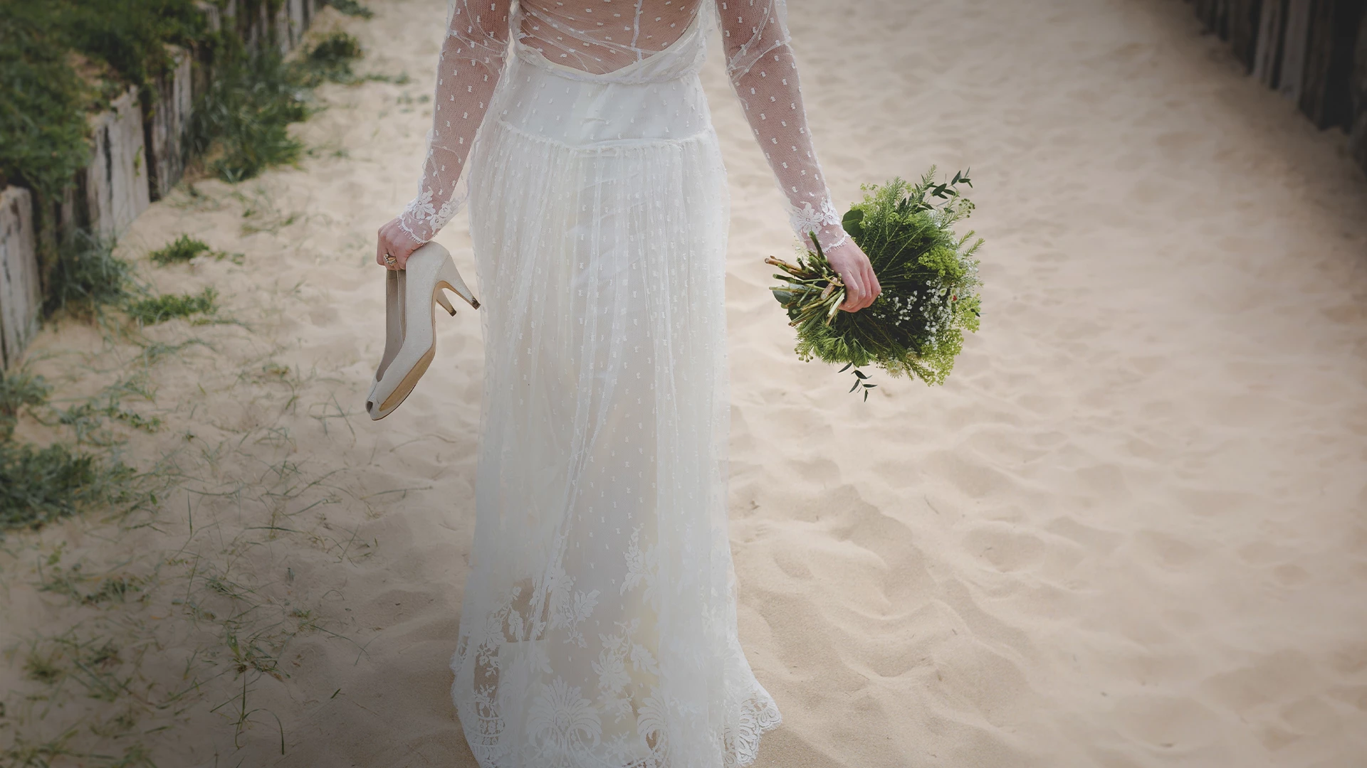 a woman in a white dress holding a bouquet of flowers and shoes