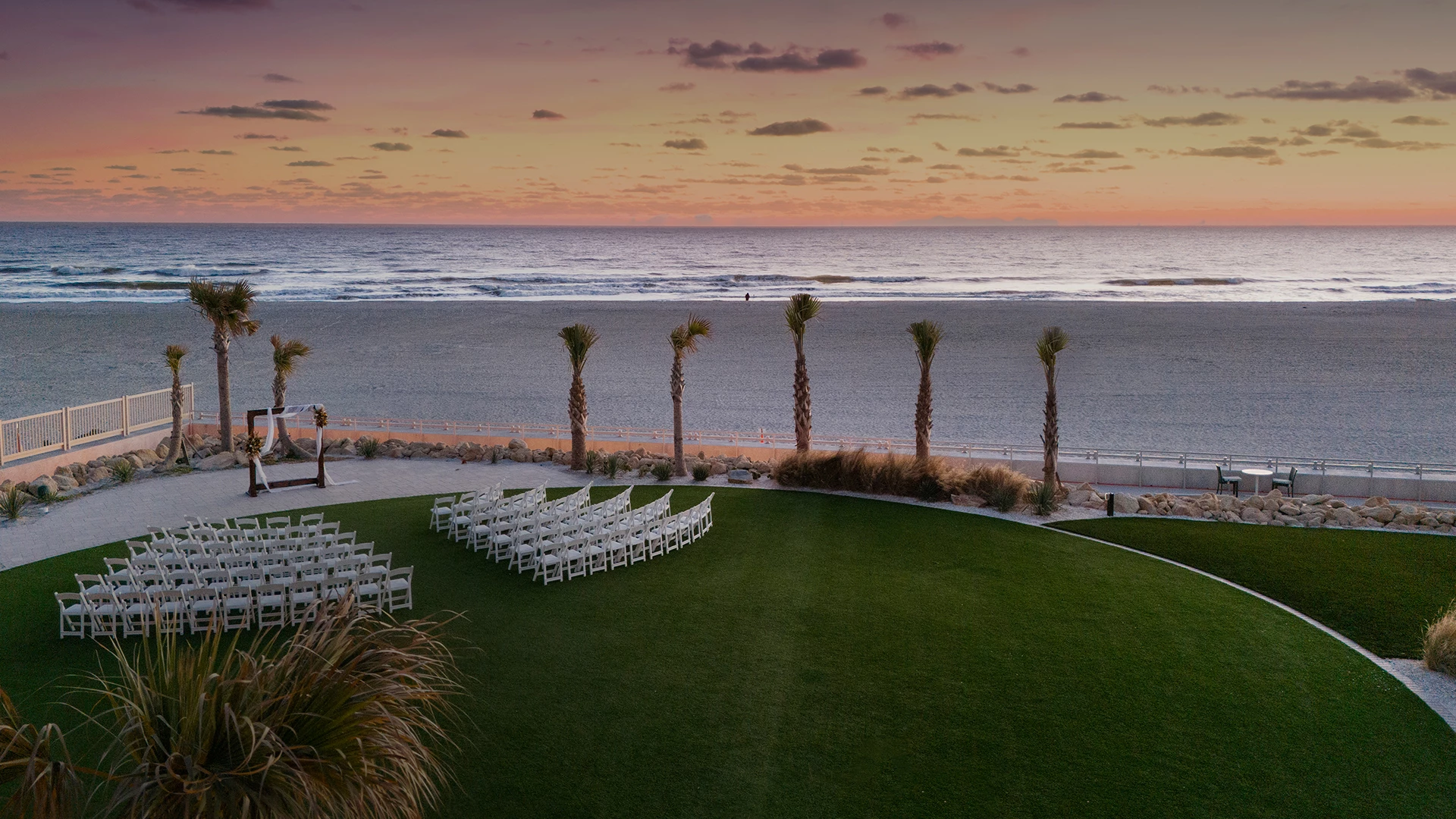 a beach with palm trees and chairs