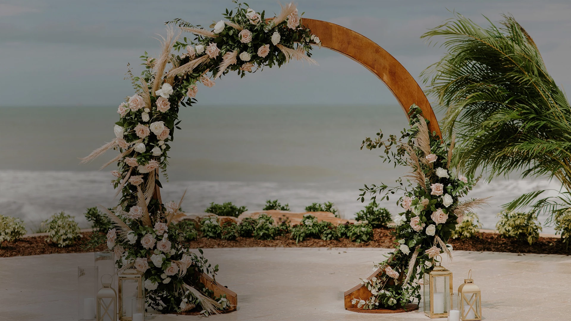 a wedding arch with flowers and plants