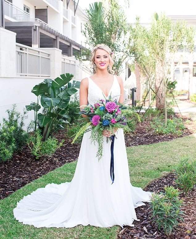 a woman in a white dress holding flowers