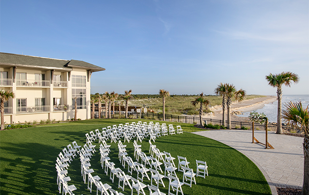 a white chairs in a circle in front of a building