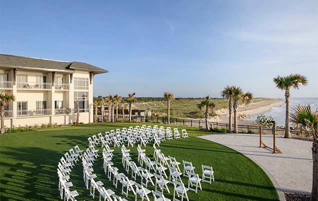 a white chairs in a circle in front of a building