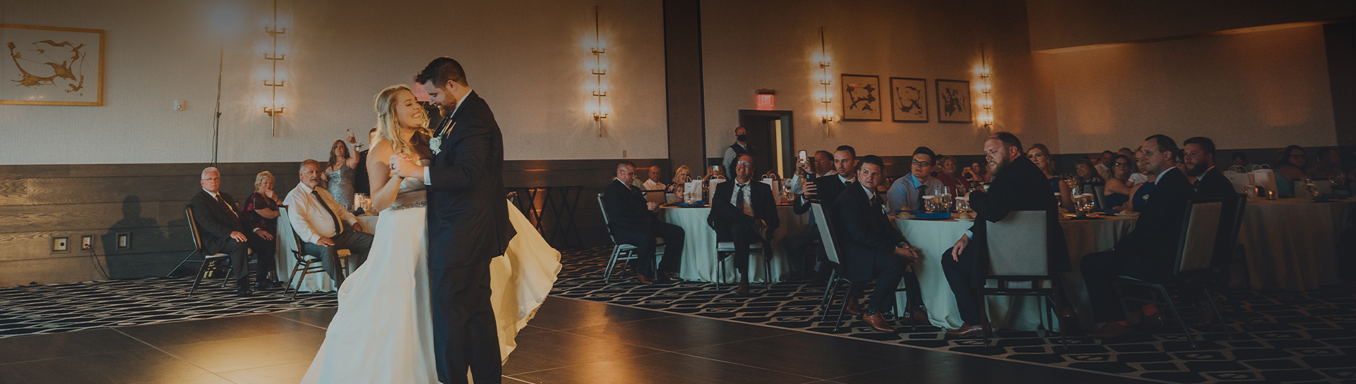 a man in a white dress standing in front of a group of people