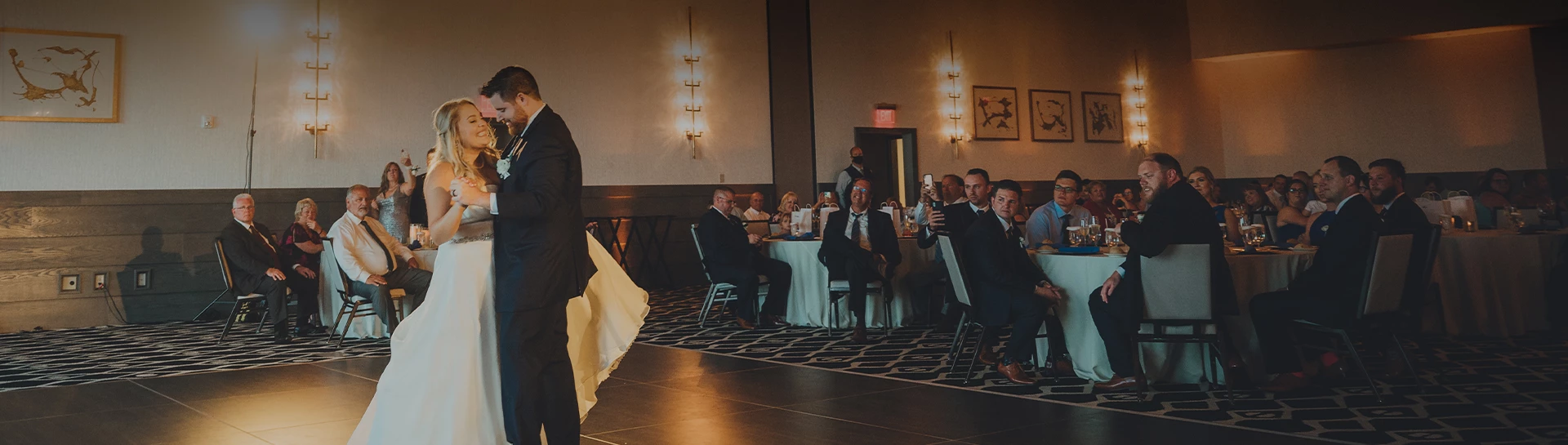 a man in a white dress standing in front of a group of people