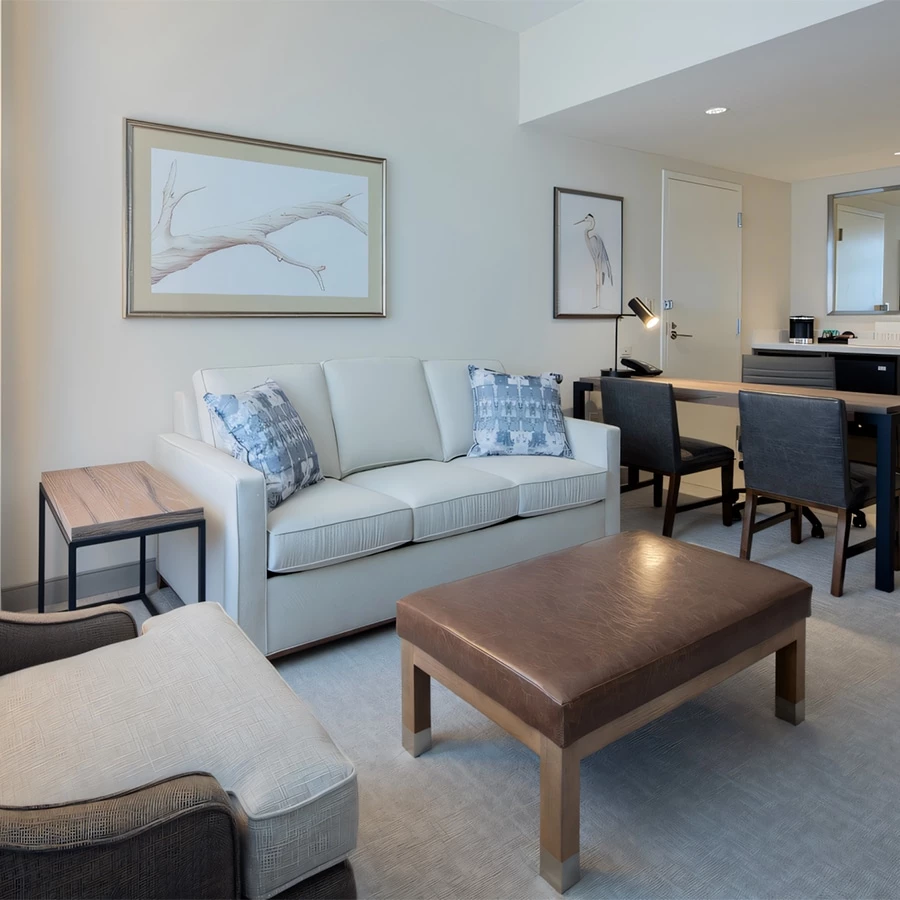 a living room with a couch and chairs